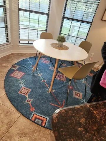 a bedroom with a bed and a large mirror