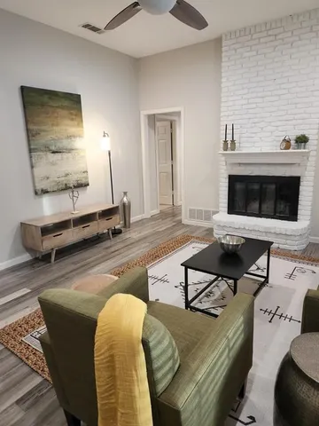 a dining room with furniture and wooden floor