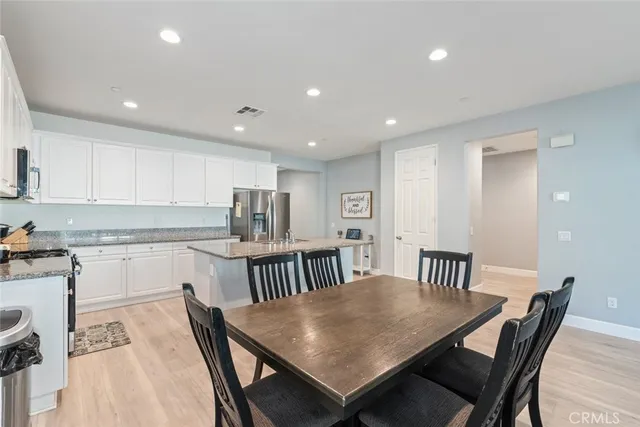 a kitchen that has a table and chairs in it