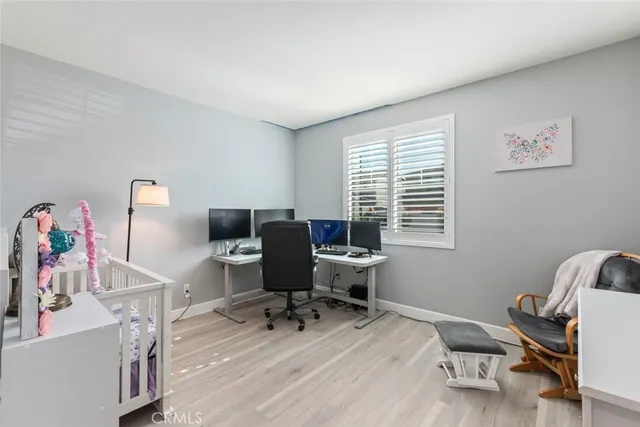 a view of a workspace with furniture and a window