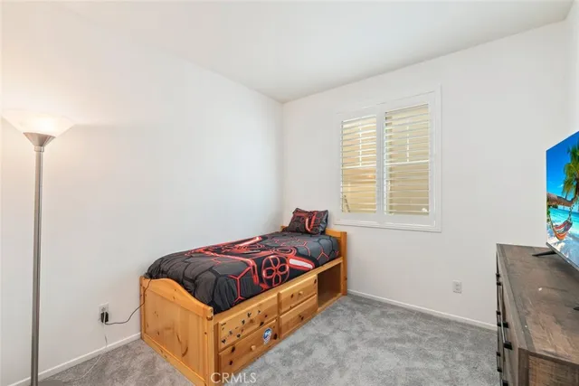 a bed room with a bed and a window