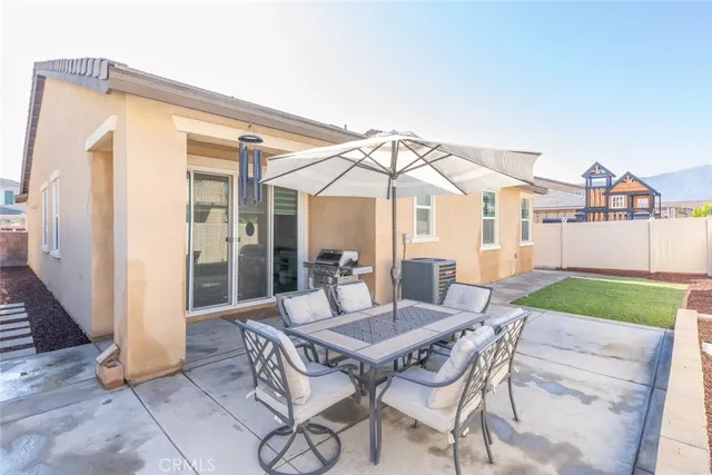 a view of a patio with a dining table and chairs