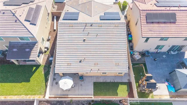 a view of a patio with couches table and chairs and potted plants