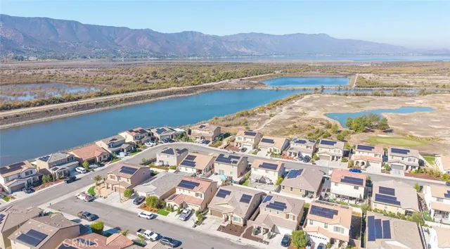 an aerial view of residential houses with yard