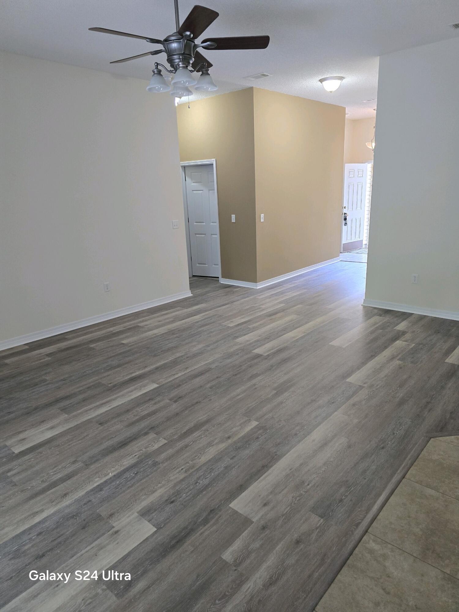 2864 Soles Lane Crestview, FL 32539 - Photo 12 of 32 a view of an empty room with wooden floor
