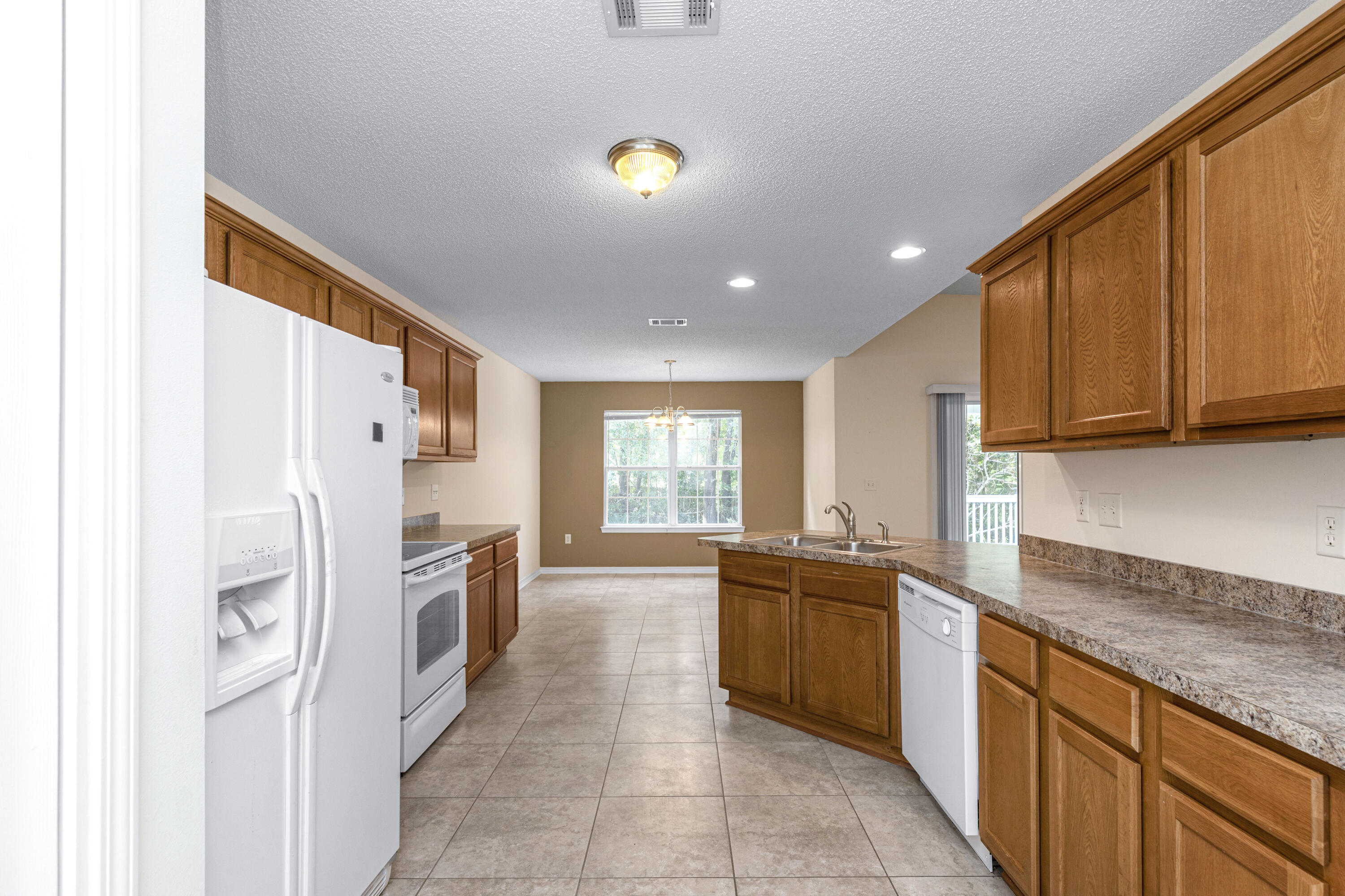 2864 Soles Lane Crestview, FL 32539 - Photo 17 of 32 a kitchen with stainless steel appliances granite countertop a refrigerator and a sink
