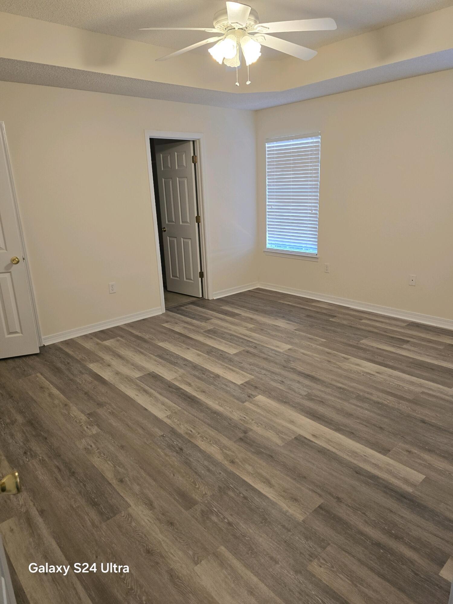 2864 Soles Lane Crestview, FL 32539 - Photo 23 of 32 a view of an empty room with wooden floor and a window