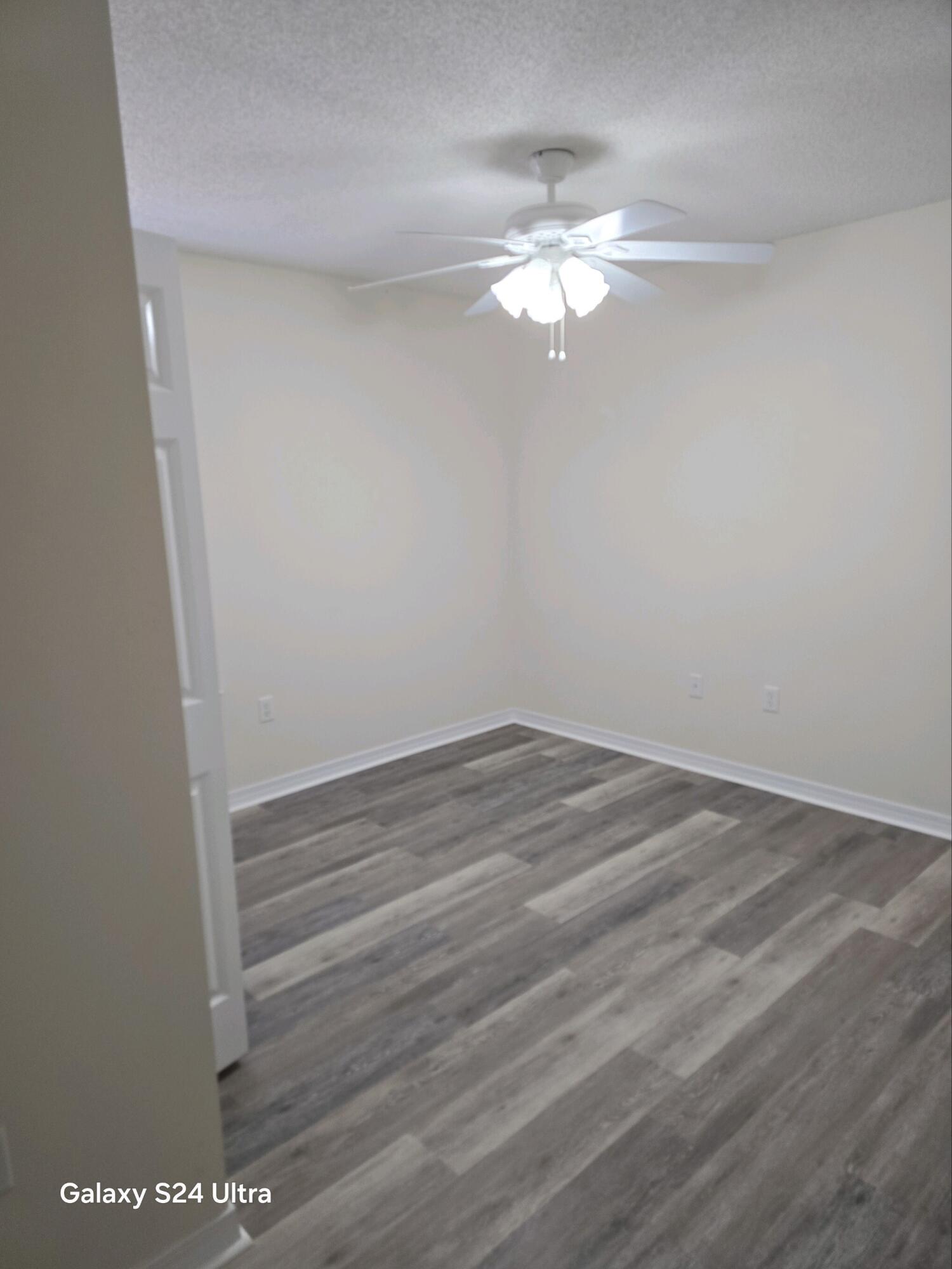 2864 Soles Lane Crestview, FL 32539 - Photo 26 of 32 a view of a room with wooden floor and fan