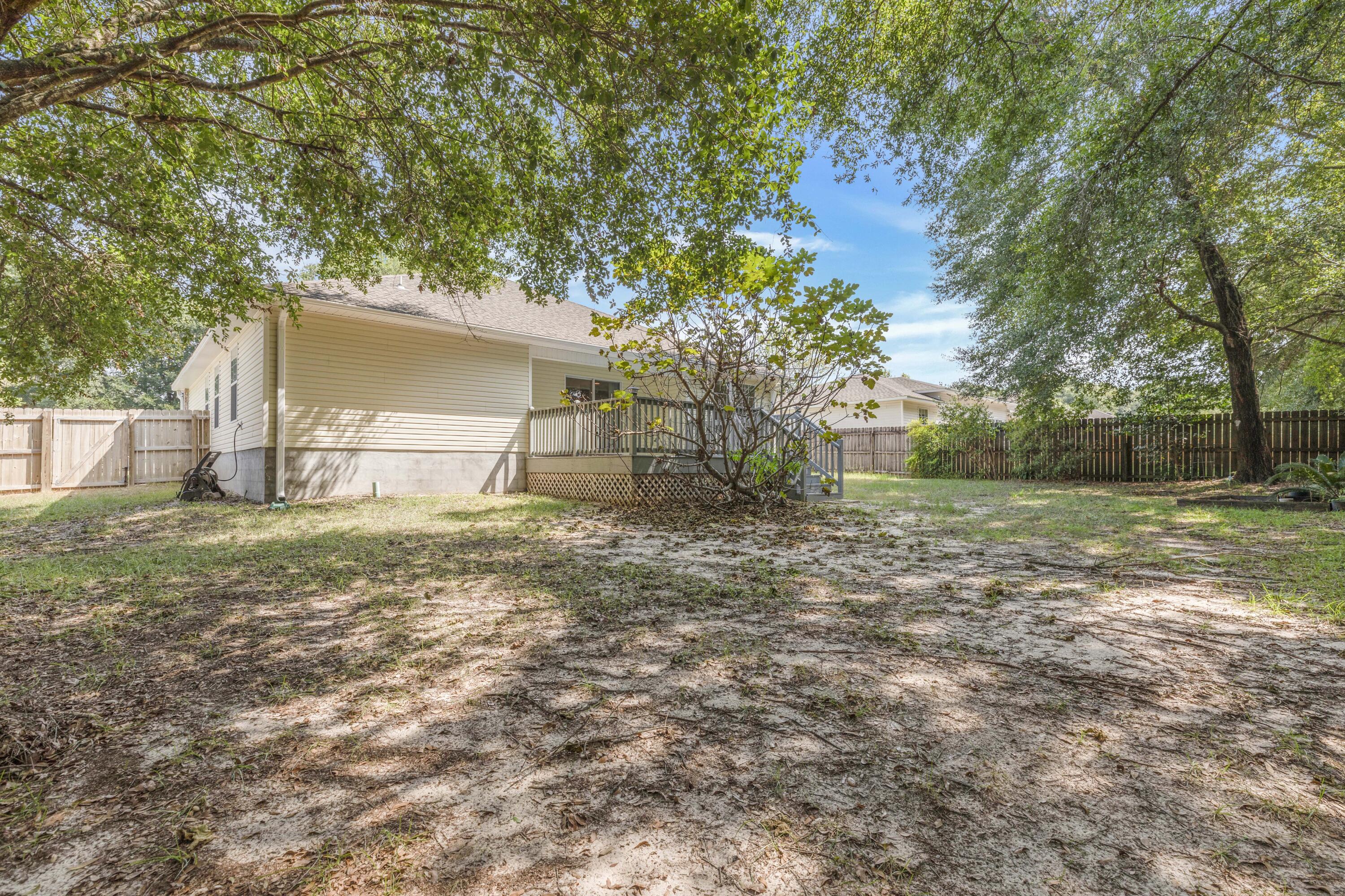 2864 Soles Lane Crestview, FL 32539 - Photo 7 of 32 a backyard of a house with lots of green space