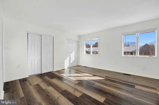 a view of a room with wooden floor