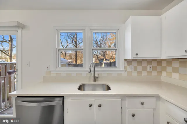 a kitchen with stainless steel appliances a sink and cabinets