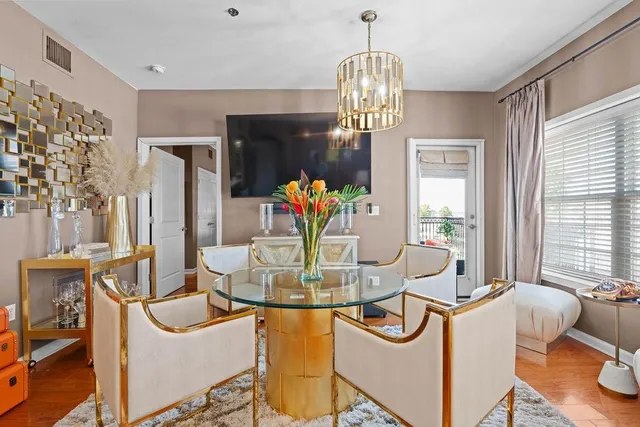 a view of a dining room with furniture and chandelier