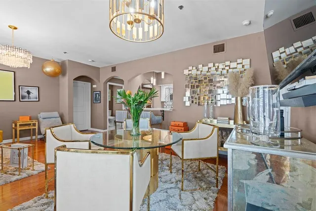 a view of a dining room with furniture and a chandelier