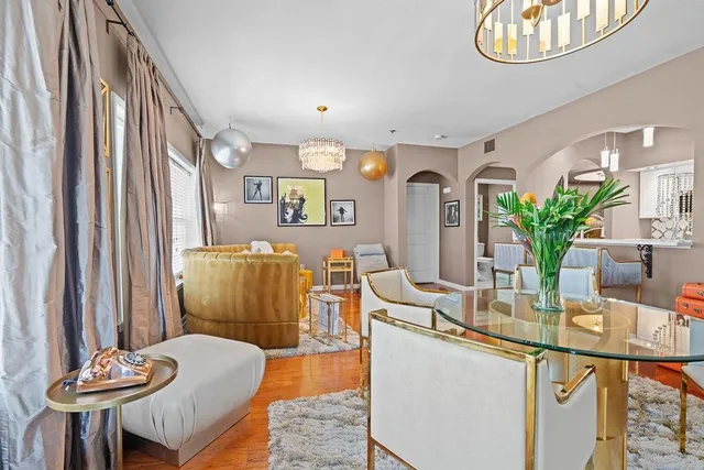 a dining room with furniture and a chandelier