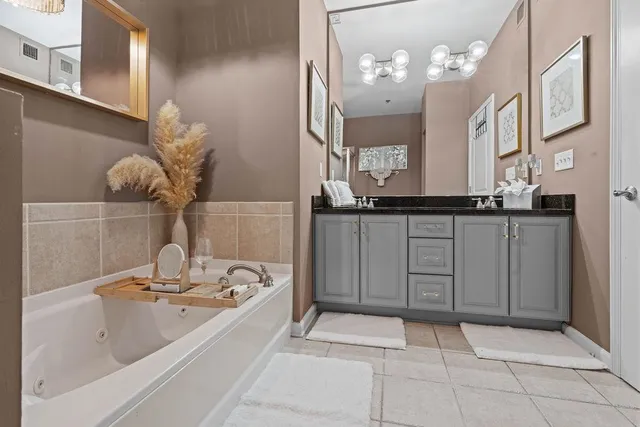 a spacious bathroom with a sink a mirror and a bathtub