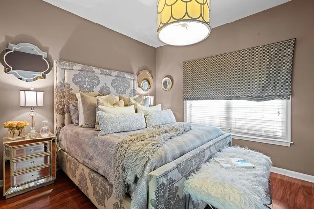 a bedroom with a bed and a chandelier