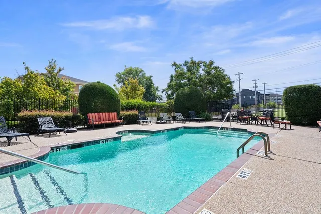 a swimming pool with outdoor seating and yard