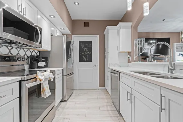 a kitchen with a sink stove and refrigerator