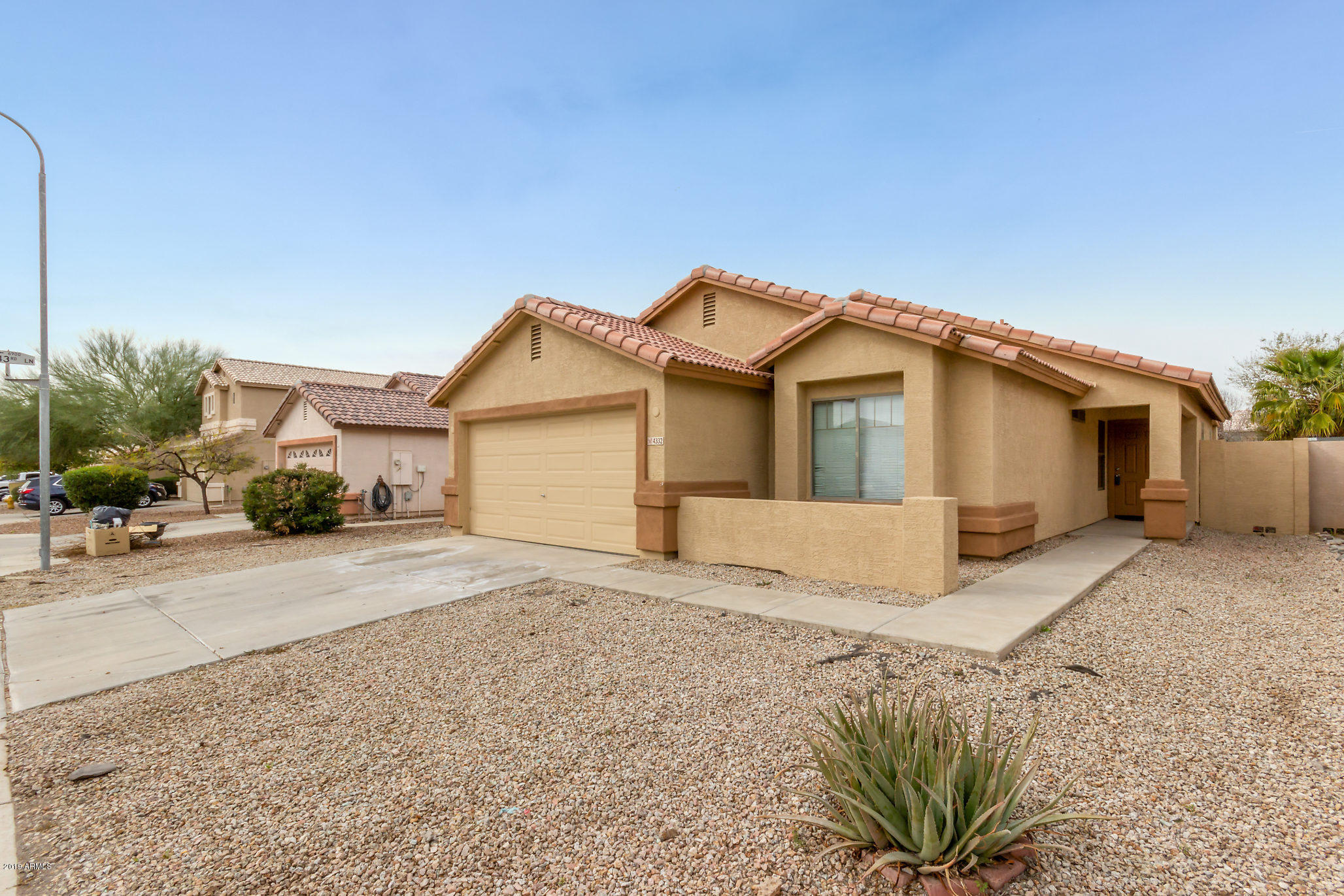 4332 West Maldonado Road Laveen, AZ 85339 - Photo 1 of 21 a view of a house with a yard and fence