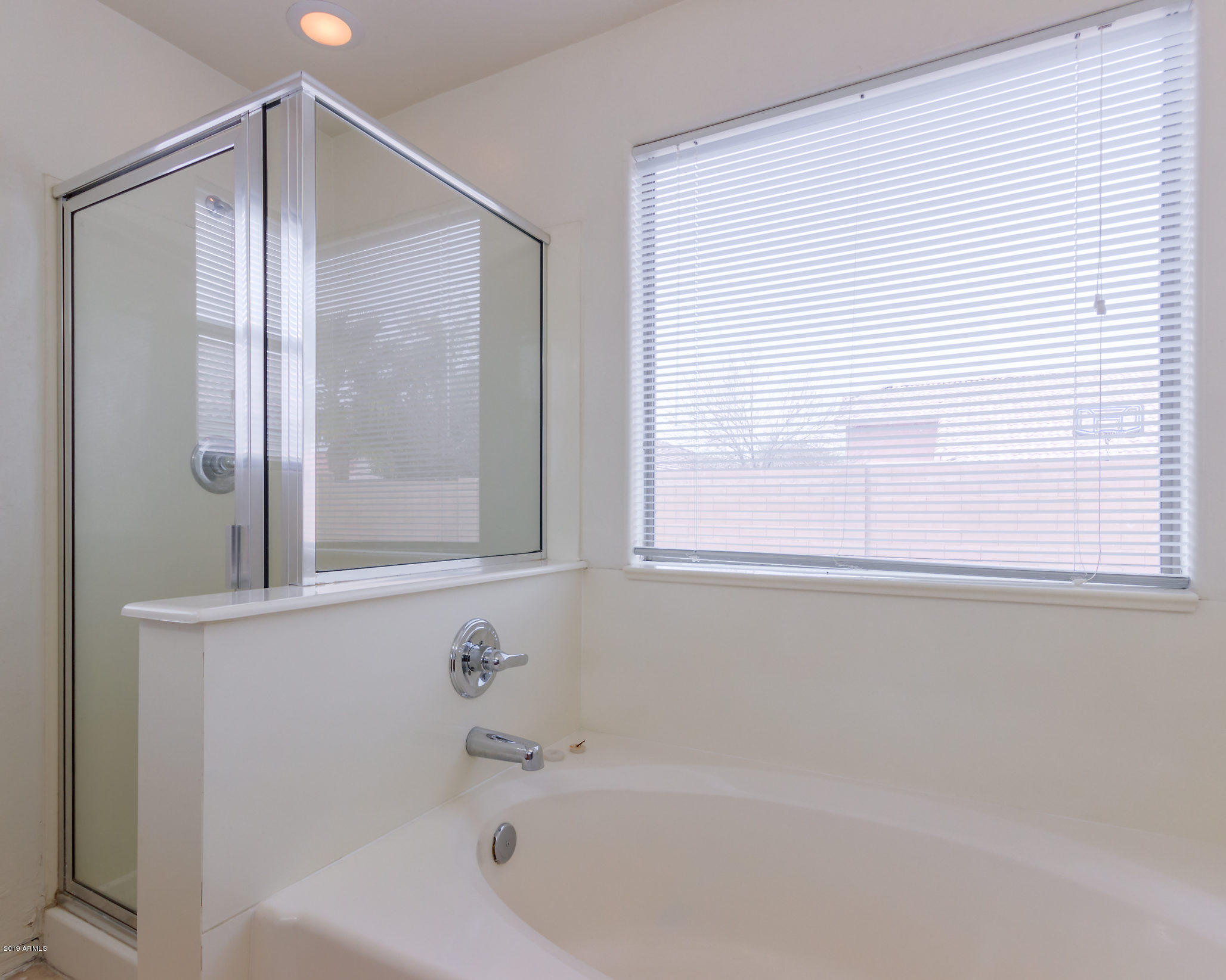 4332 West Maldonado Road Laveen, AZ 85339 - Photo 11 of 21 a bathroom with a bathtub and a shower