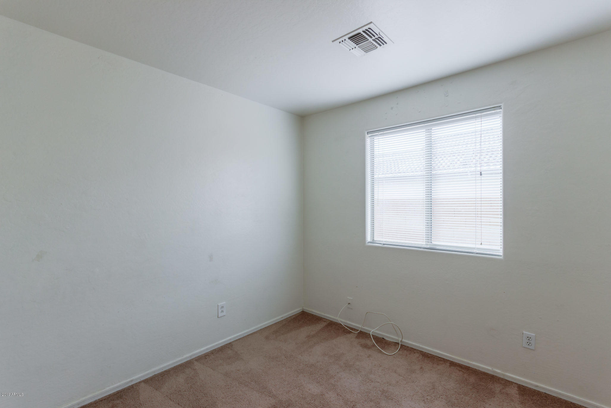 4332 West Maldonado Road Laveen, AZ 85339 - Photo 16 of 21 an empty room with a window
