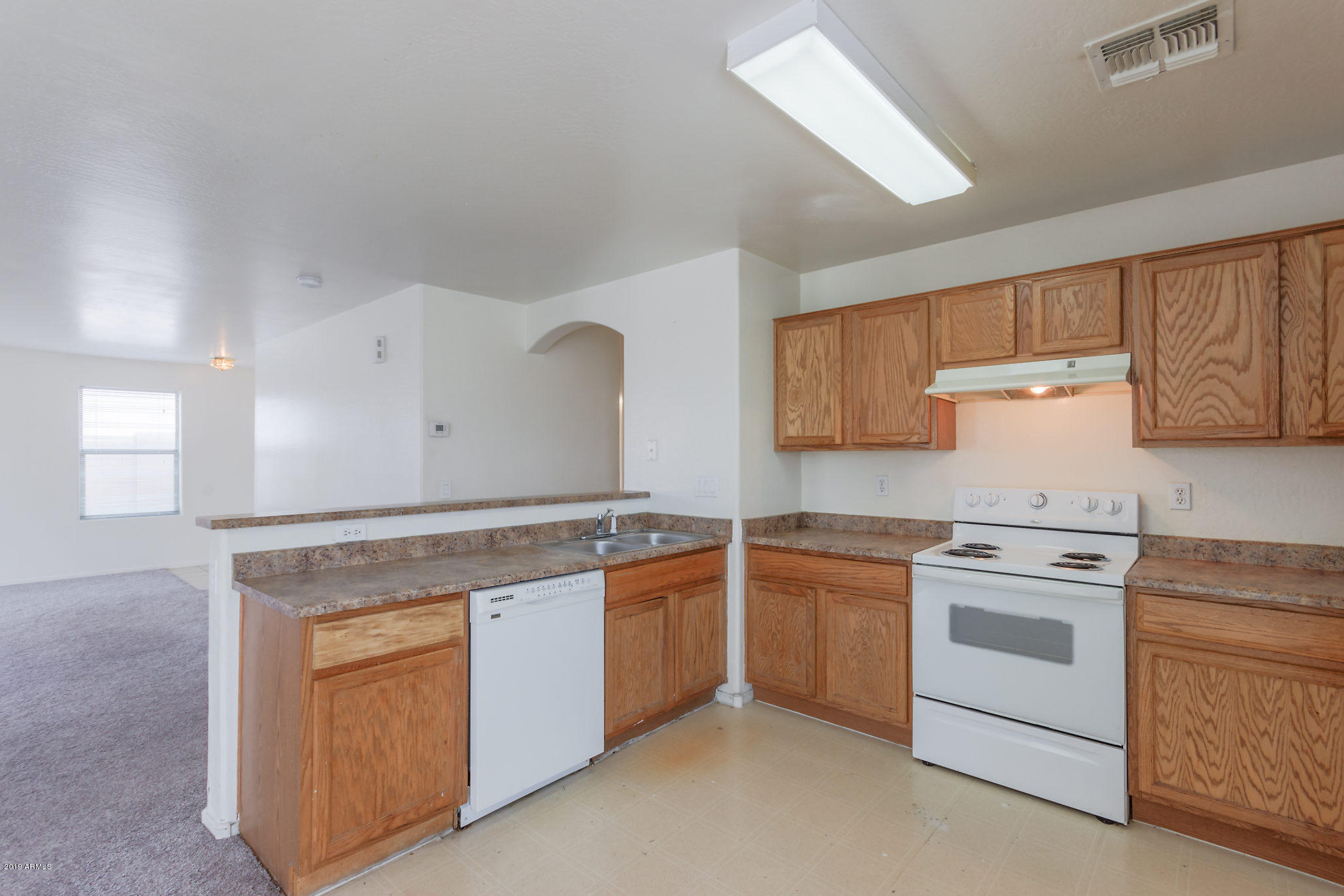 4332 West Maldonado Road Laveen, AZ 85339 - Photo 2 of 21 a kitchen with white cabinets stainless steel appliances and sink