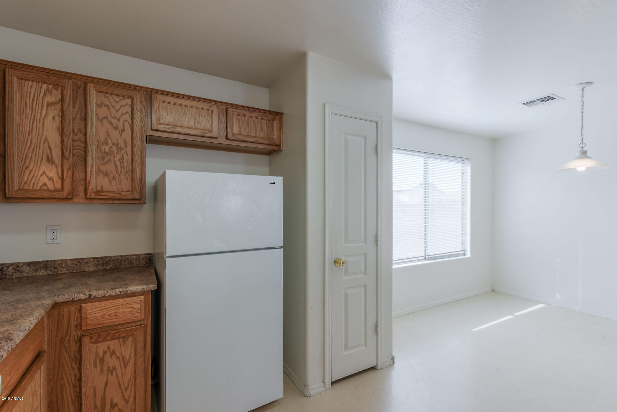 4332 West Maldonado Road Laveen, AZ 85339 - Photo 4 of 21 a view of a kitchen with a refrigerator cabinet and a sink