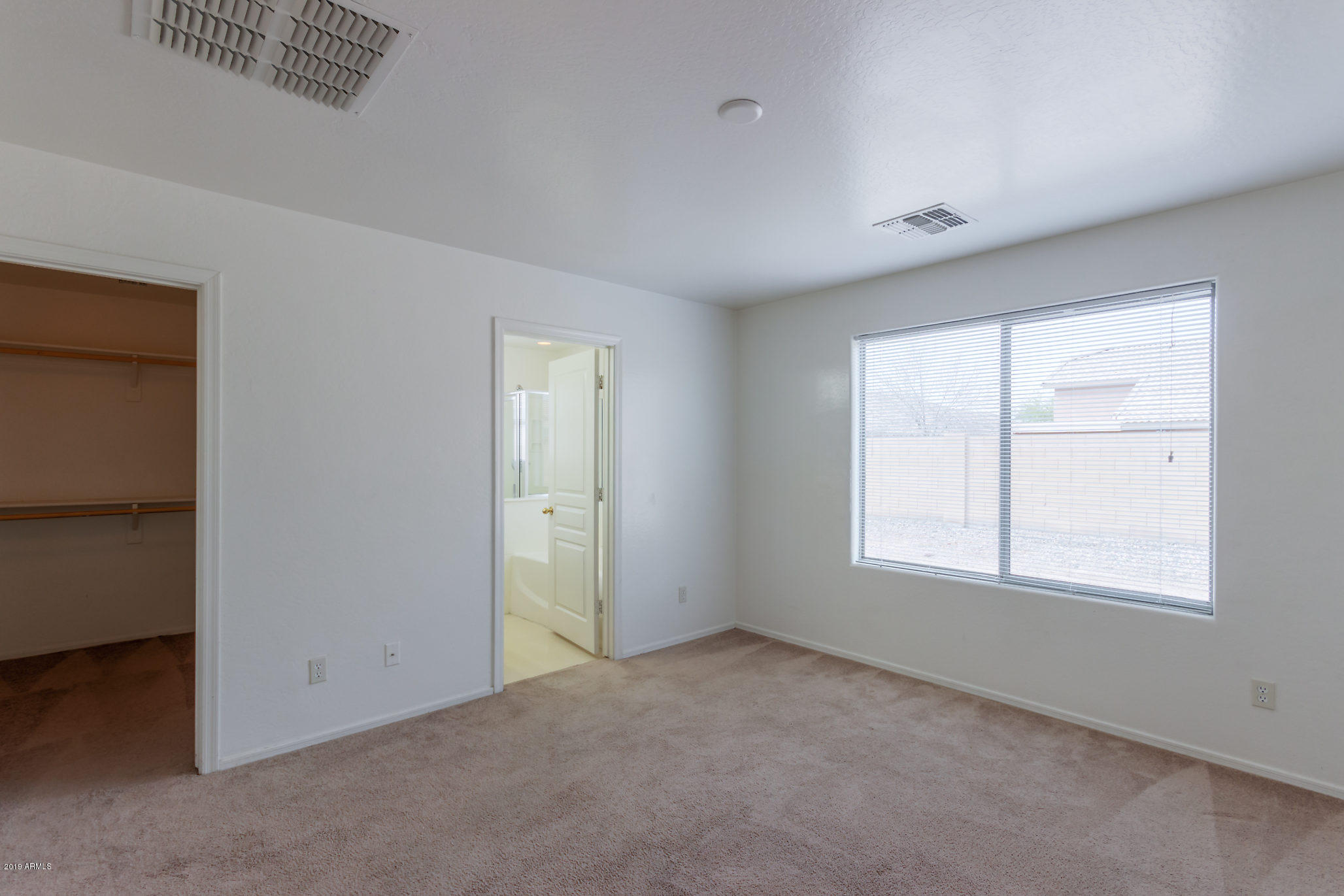 4332 West Maldonado Road Laveen, AZ 85339 - Photo 9 of 21 an empty room with windows