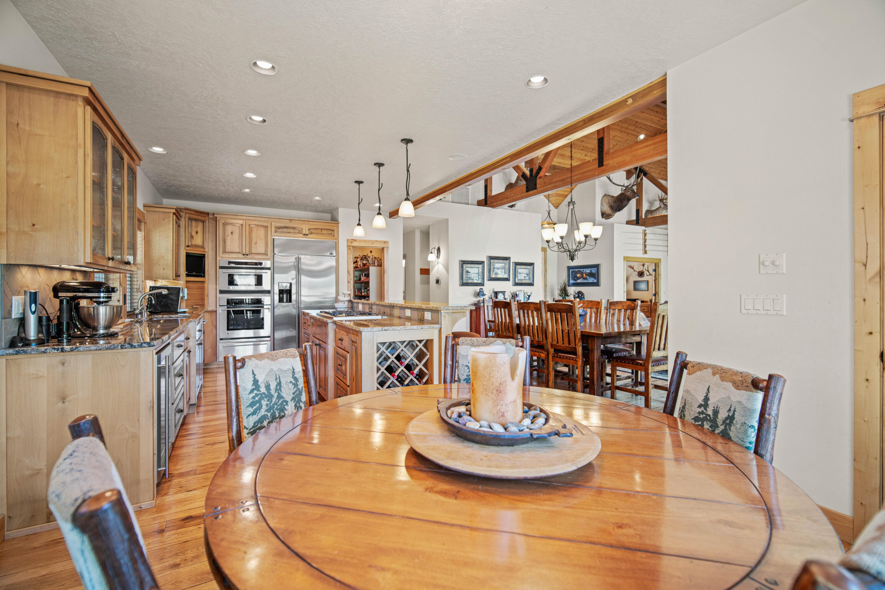 56689 Dancing Rock Loop Bend, OR 97707 - Photo 13 of 51 a dining room with furniture a table and kitchen view
