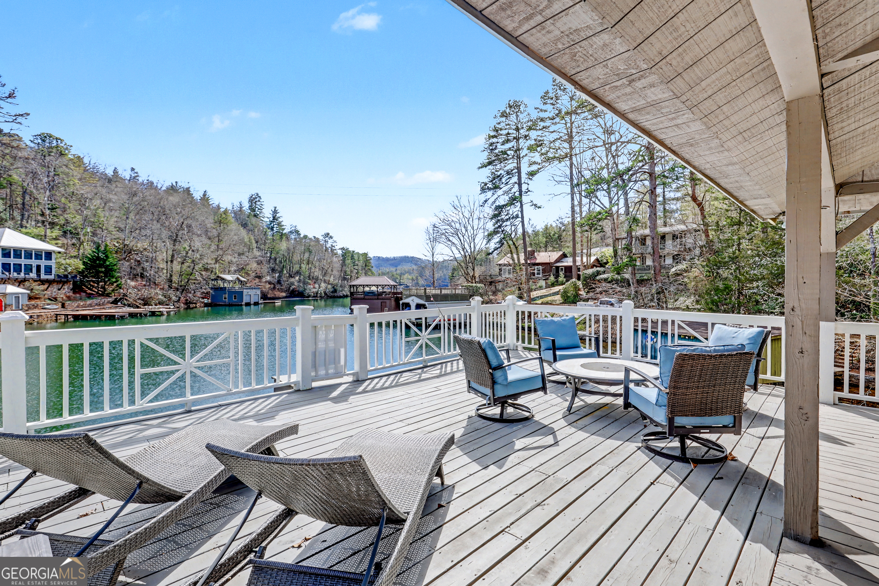 336 Fulton Road Tiger, GA 30576 - Photo 11 of 52 a balcony with wooden benches and seating
