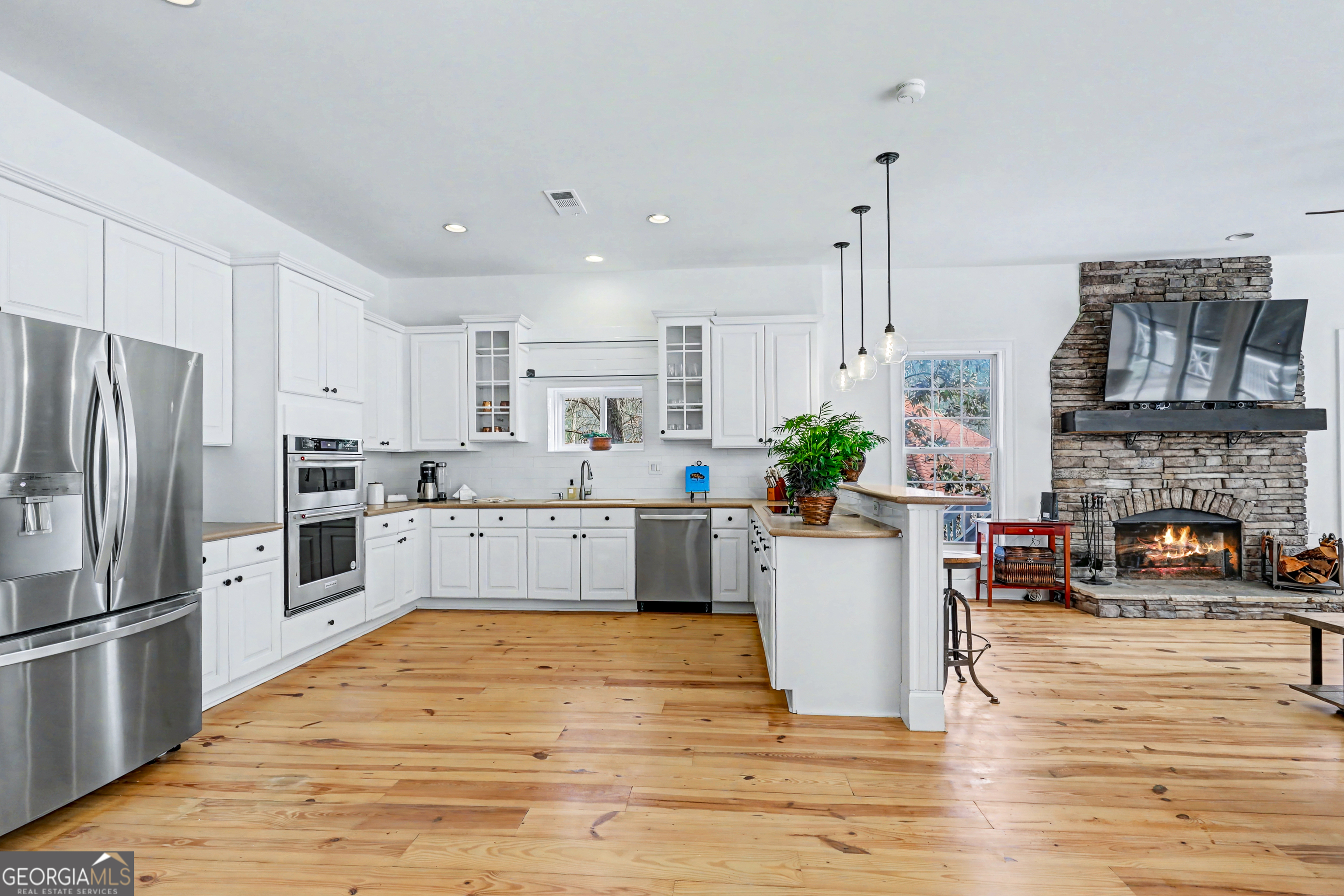 336 Fulton Road Tiger, GA 30576 - Photo 20 of 52 a kitchen with stainless steel appliances granite countertop a refrigerator a oven a stove and a wooden floors