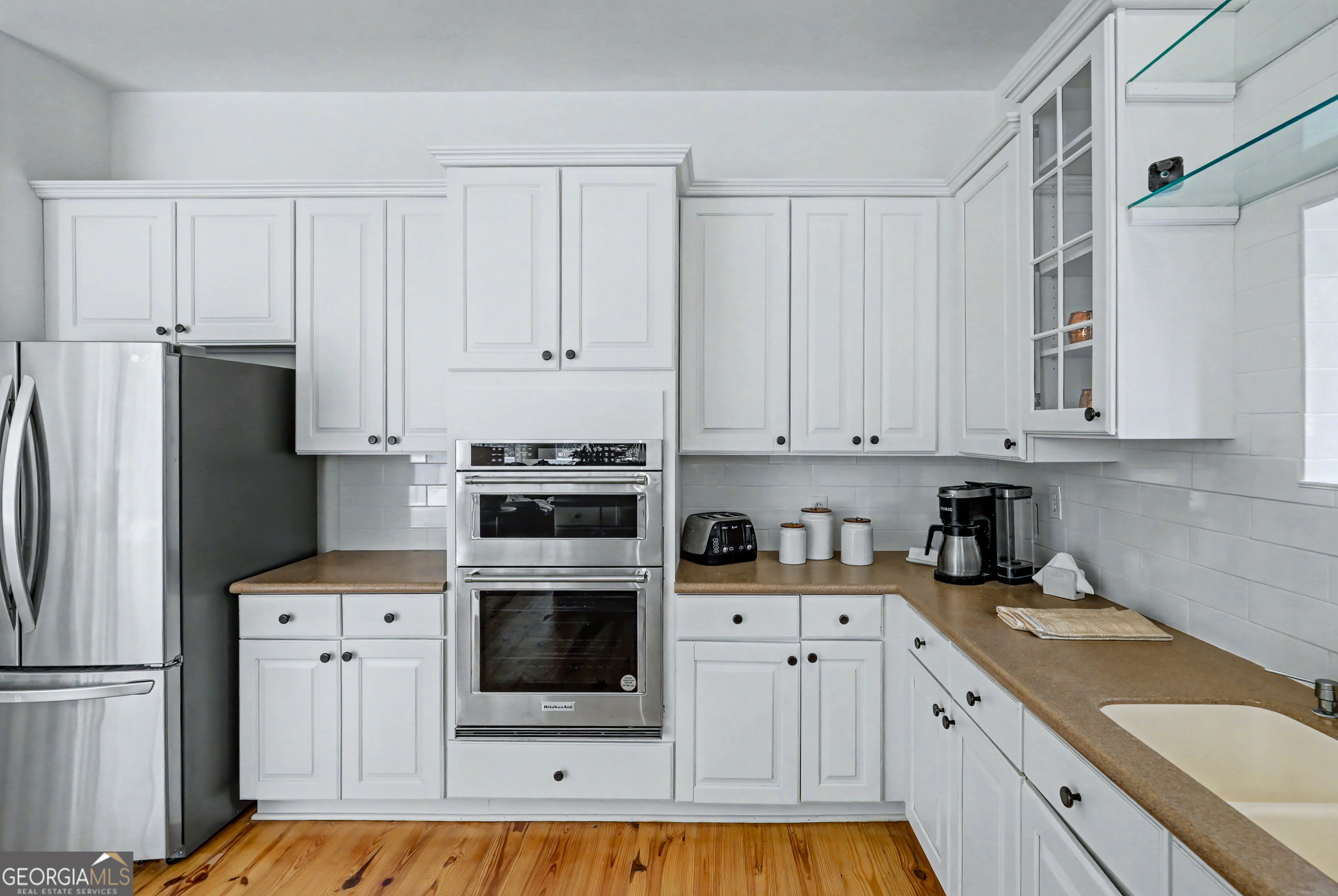 336 Fulton Road Tiger, GA 30576 - Photo 21 of 52 a kitchen with white cabinets and refrigerator