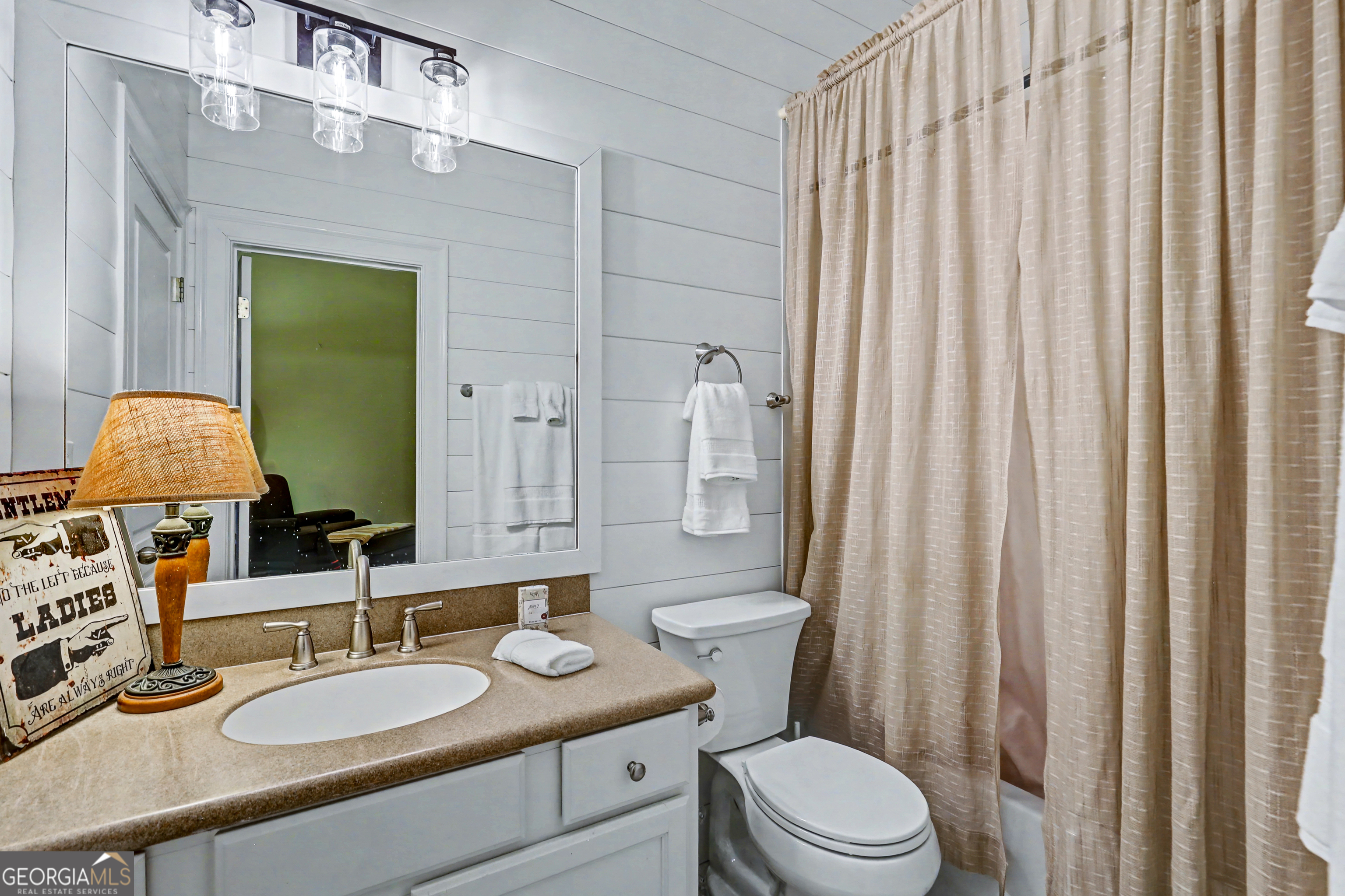 336 Fulton Road Tiger, GA 30576 - Photo 29 of 52 a bathroom with a granite countertop sink vanity mirror and toilet