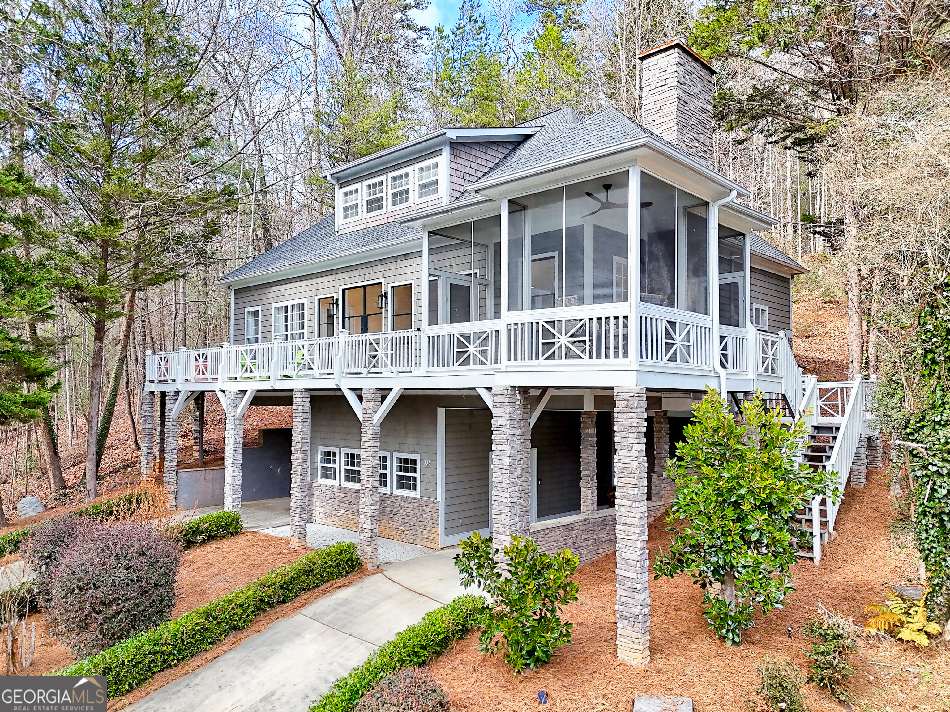 336 Fulton Road Tiger, GA 30576 - Photo 3 of 52 a front view of a residential apartment building with a yard and potted plants