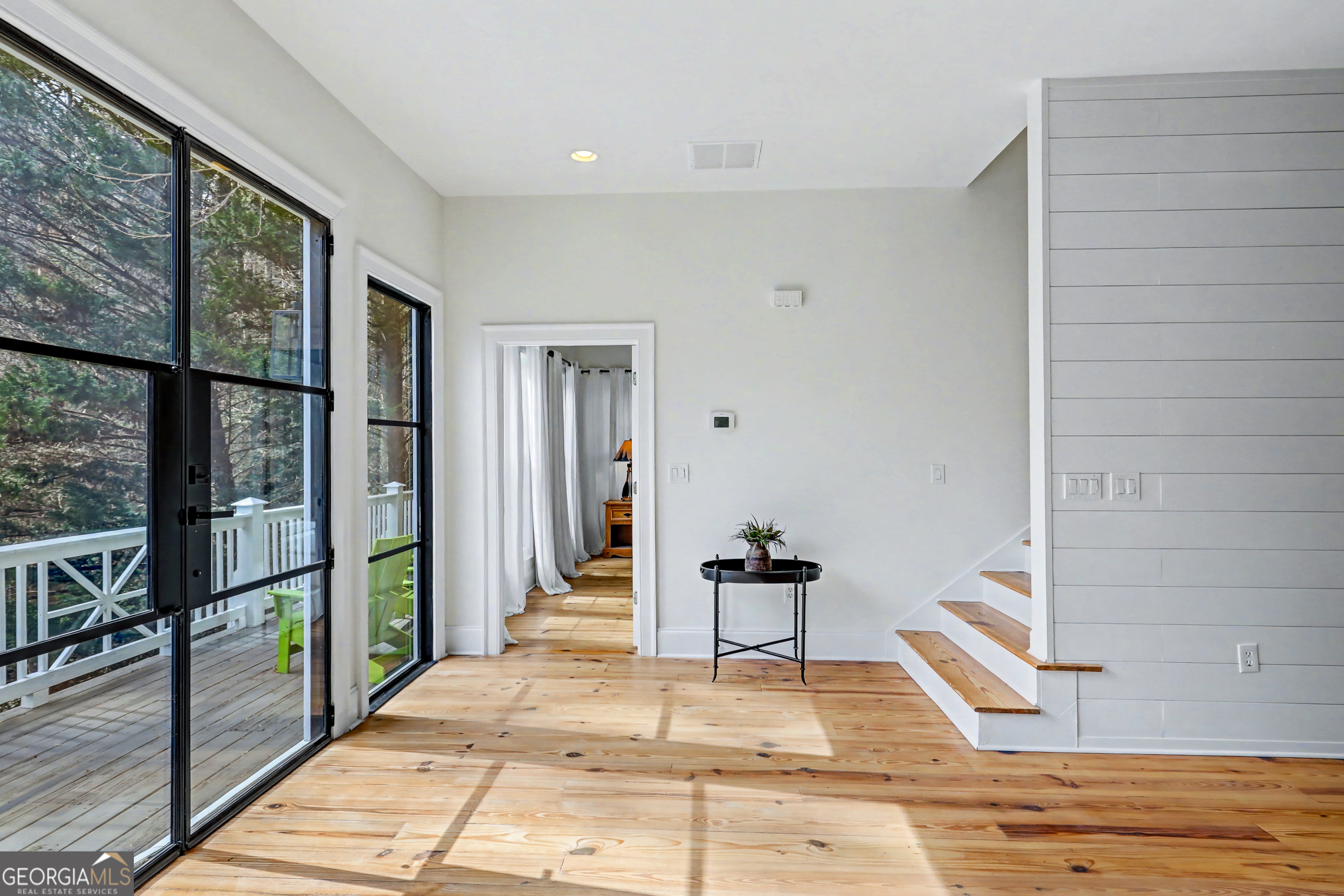 336 Fulton Road Tiger, GA 30576 - Photo 33 of 52 a view of an empty room with wooden floor and a floor to ceiling window
