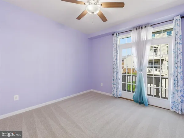 a view of an empty room with a ceiling fan