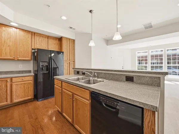 a kitchen with stainless steel appliances white cabinets and a stove top oven