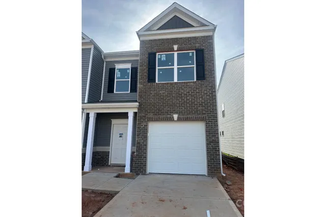 a view of a house with more windows and brick walls