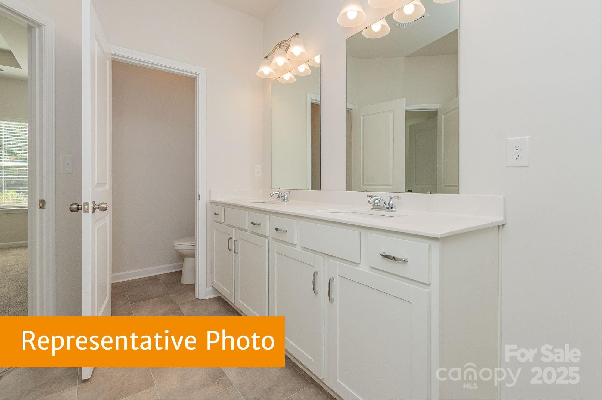 6028 Jasmine Br Road Charlotte, NC 28216 - Photo 18 of 29 a bathroom with a sink a mirror and a shower