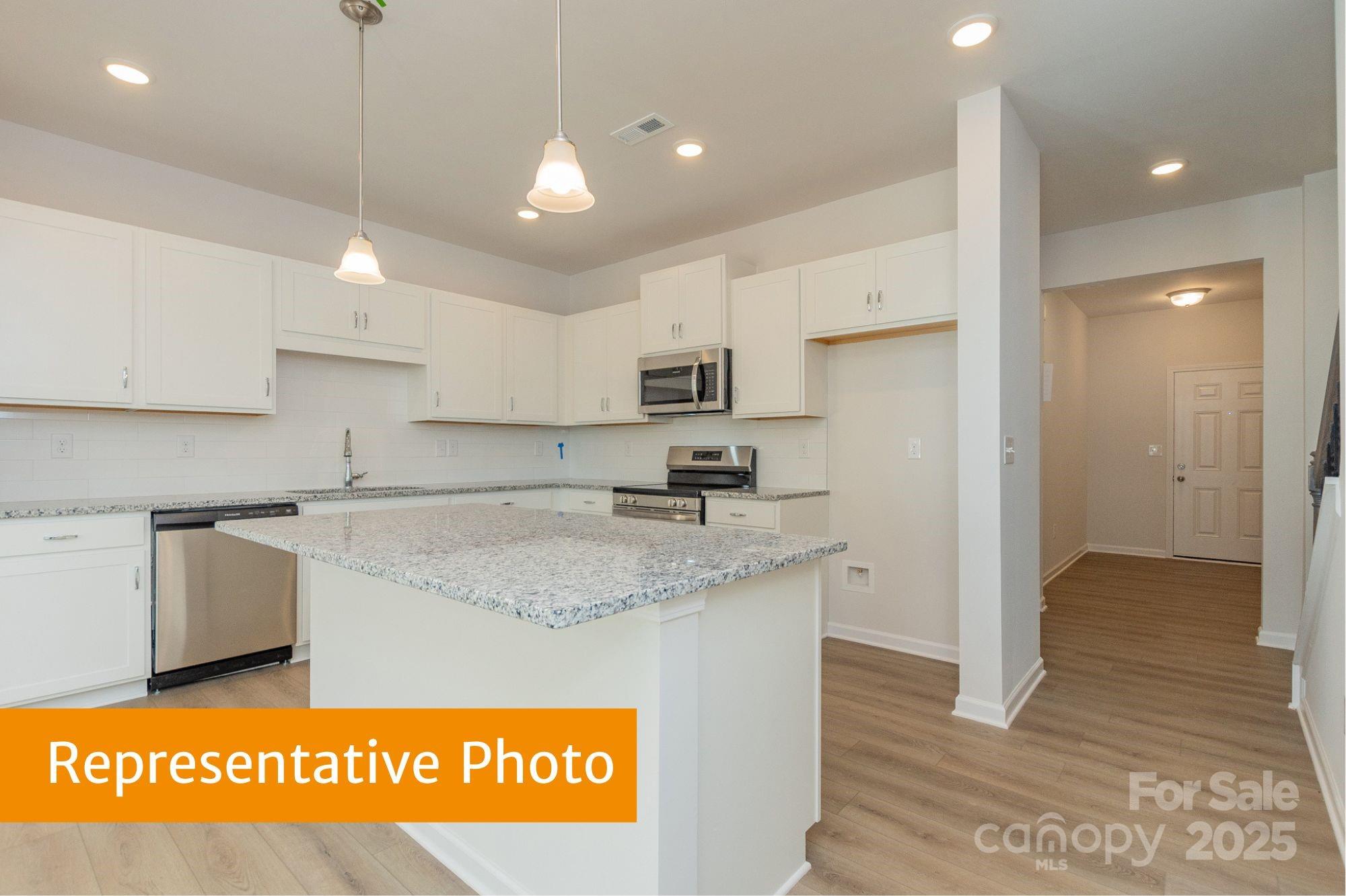 6028 Jasmine Br Road Charlotte, NC 28216 - Photo 2 of 29 a kitchen with stainless steel appliances granite countertop a sink a stove a refrigerator a center island and cabinets