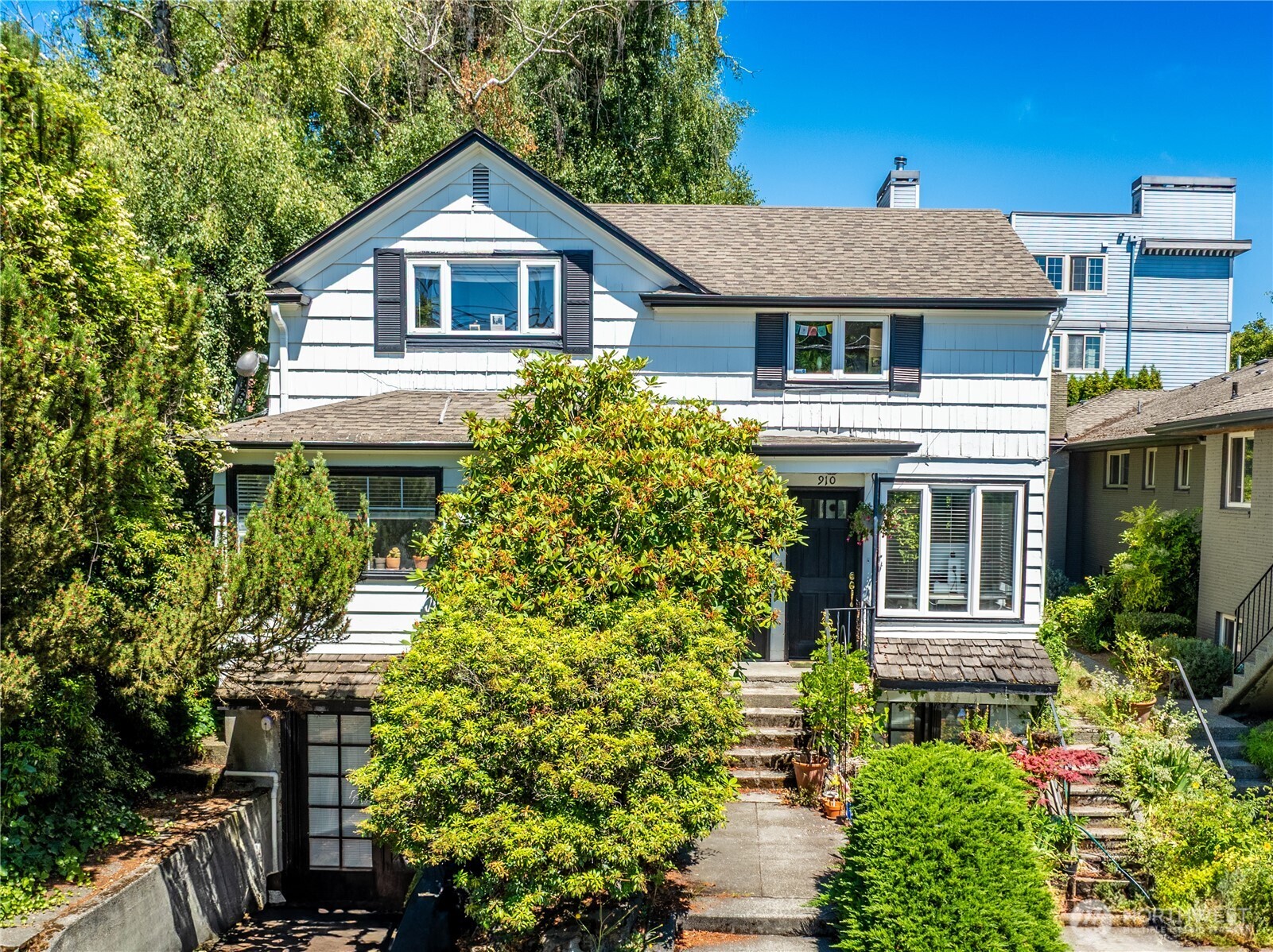 a front view of a house with a garden