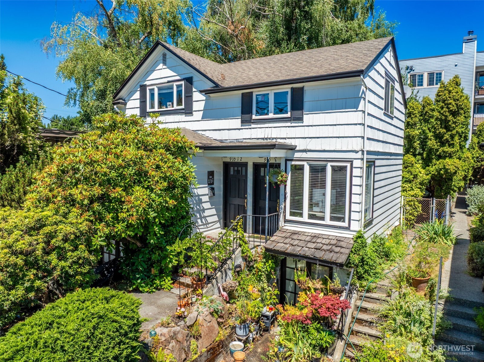 910 East Prospect Street Seattle, WA 98102 - Photo 2 of 25 a front view of a house with a yard and potted plants