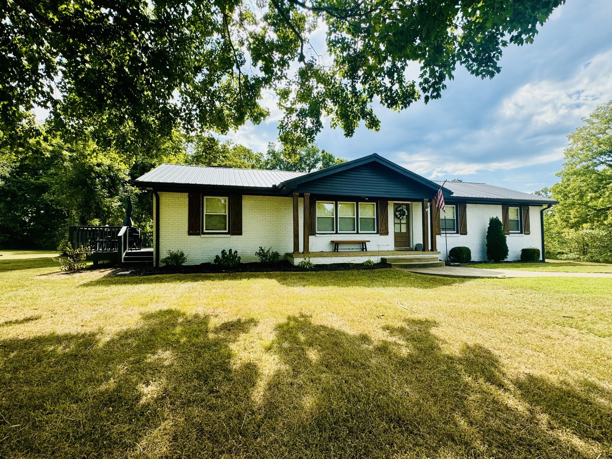 a front view of a house with swimming pool having outdoor seating