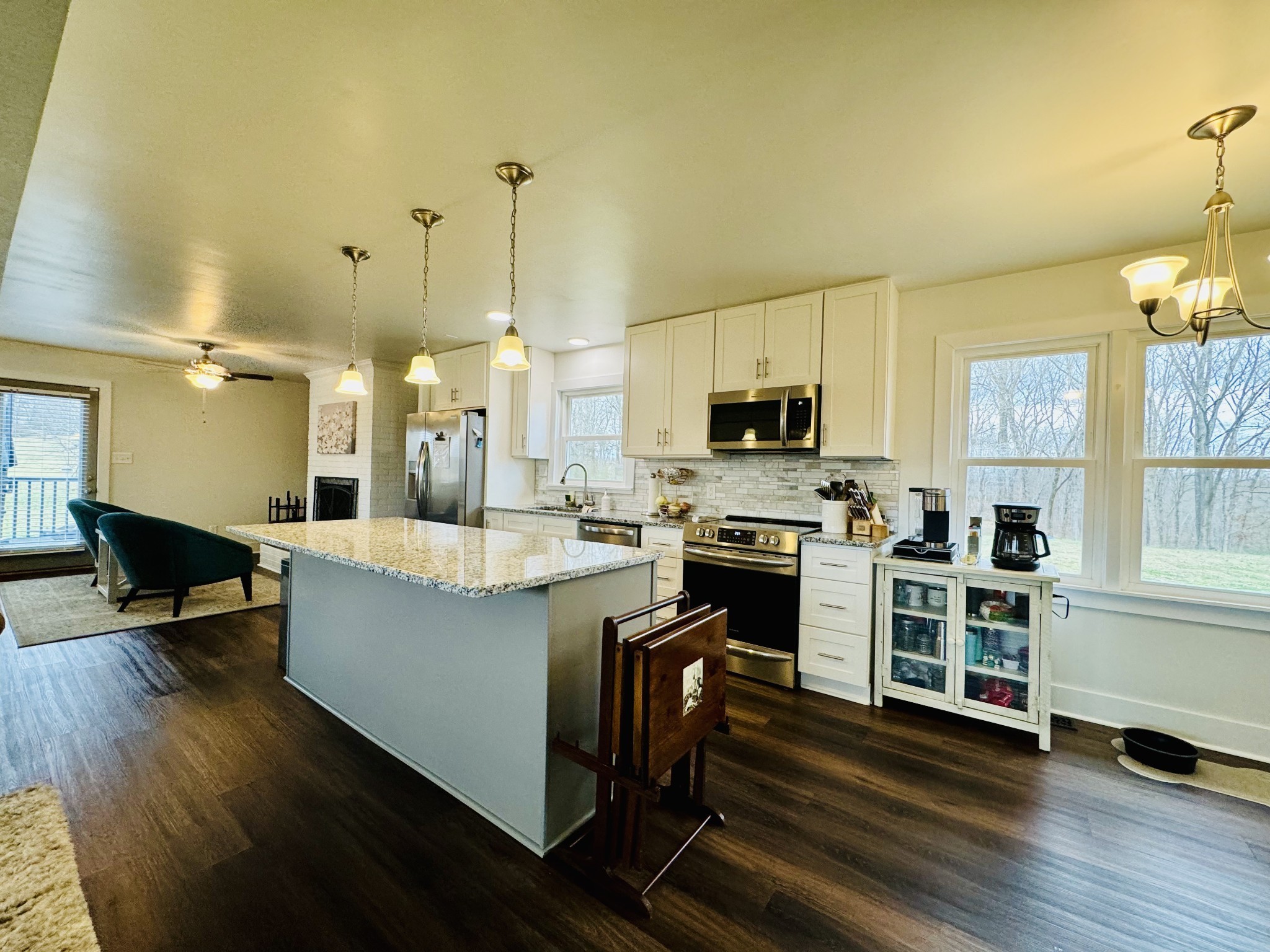 1175 Rock Church Road Dickson, TN 37055 - Photo 19 of 60 a large kitchen with stainless steel appliances a stove a sink dishwasher a microwave oven and a dining table with wooden floor