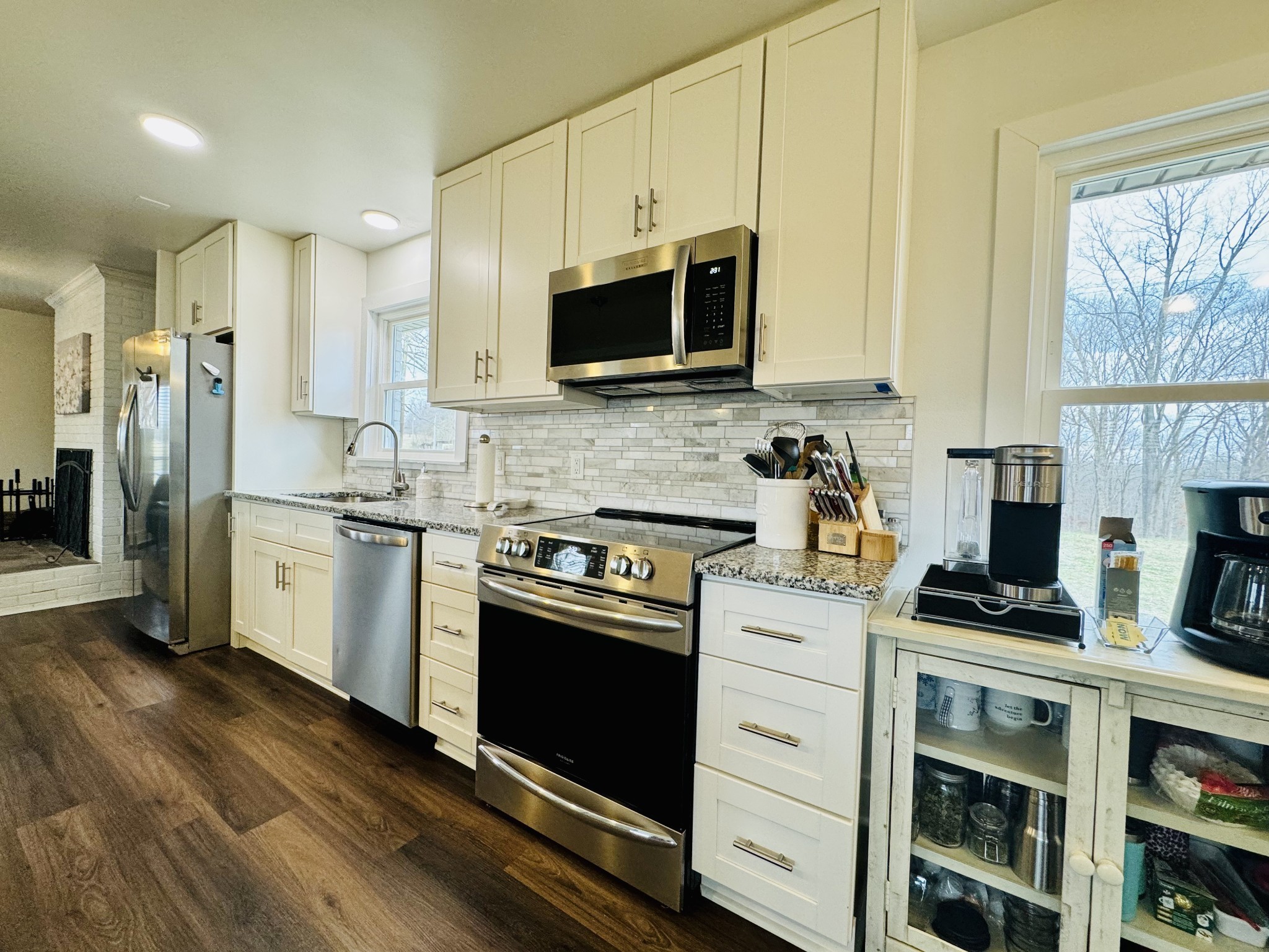 1175 Rock Church Road Dickson, TN 37055 - Photo 20 of 60 a kitchen with stainless steel appliances white cabinets and a stove top oven