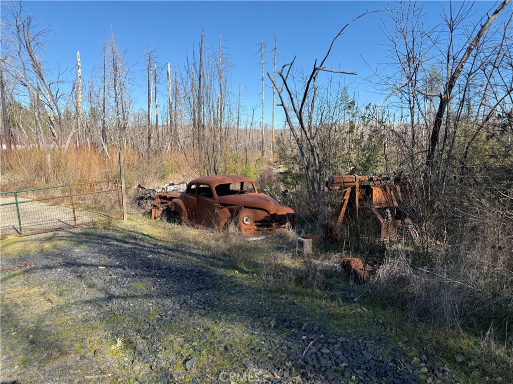 0 Inalane Berry Creek, CA 95916 - Photo 6 of 8 a view of backyard with table and chairs and wooden fence