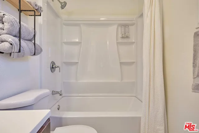 a bathroom with a shower and a toilet