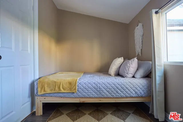 a bedroom with a bed and window