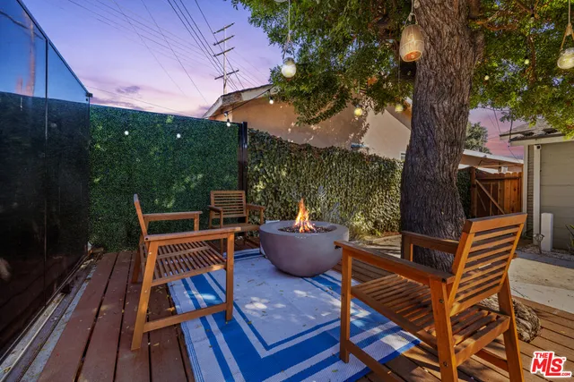 a view of a patio with iron fence