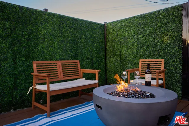 a wooden deck with a table and a chairs